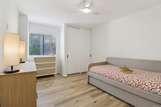 bedroom with ceiling fan, a closet, and light wood-type flooring