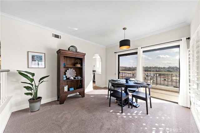 dining area with crown molding and carpet floors