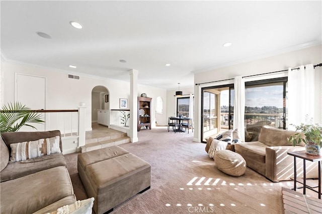 living room with ornamental molding and light colored carpet