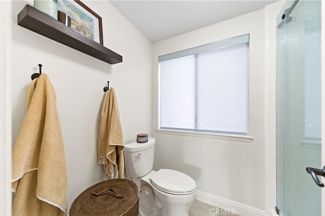 bathroom featuring toilet and walk in shower