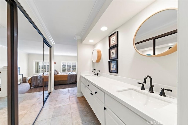 bathroom featuring ornamental molding, vanity, and tile patterned floors