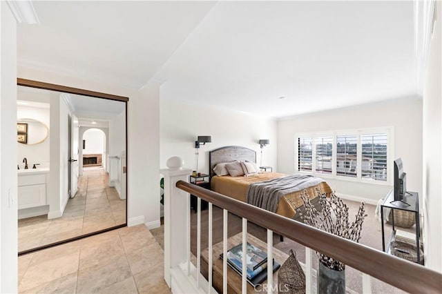 bedroom featuring sink and light tile patterned floors