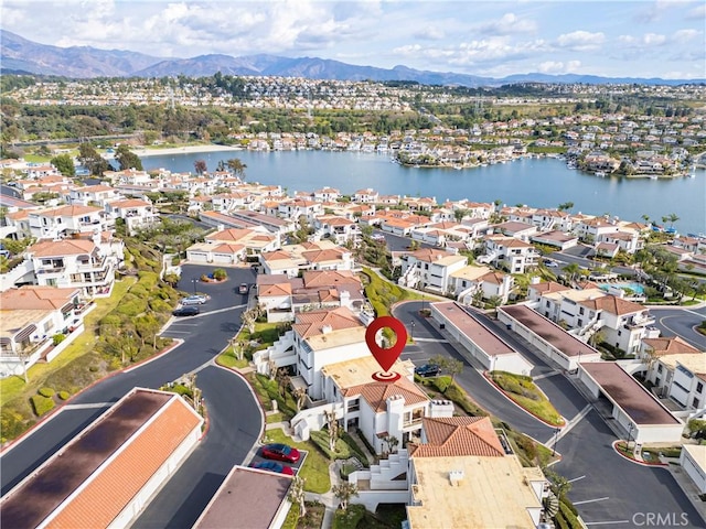 birds eye view of property featuring a water and mountain view