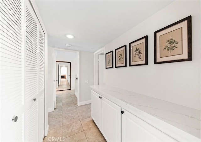 corridor with light tile patterned floors