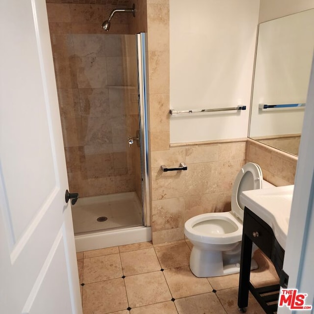 bathroom featuring tile patterned flooring, a shower with door, toilet, and tile walls