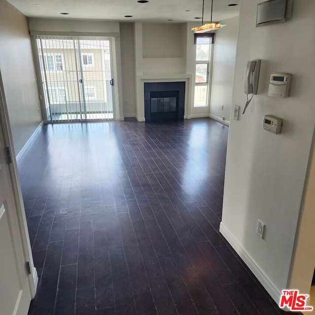 unfurnished living room featuring dark hardwood / wood-style floors