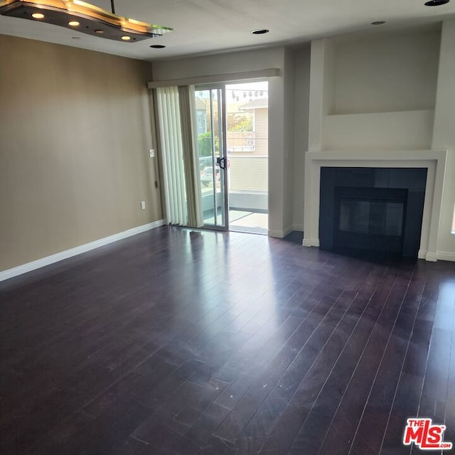 unfurnished living room featuring dark hardwood / wood-style floors