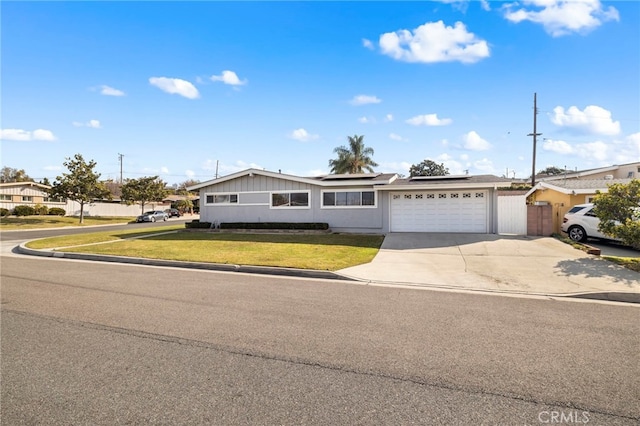 ranch-style house featuring a garage and a front yard