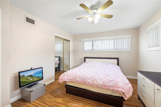 bedroom featuring ceiling fan, a closet, and light wood-type flooring