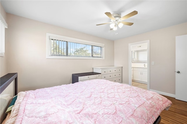 bedroom featuring ensuite bath, light hardwood / wood-style flooring, and ceiling fan