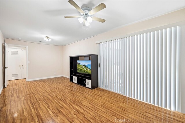 unfurnished living room featuring hardwood / wood-style floors and ceiling fan