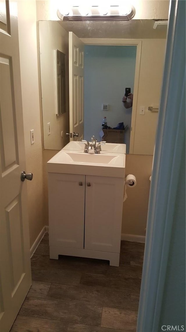 bathroom with vanity and hardwood / wood-style floors