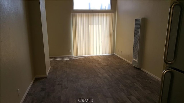 spare room with dark hardwood / wood-style flooring