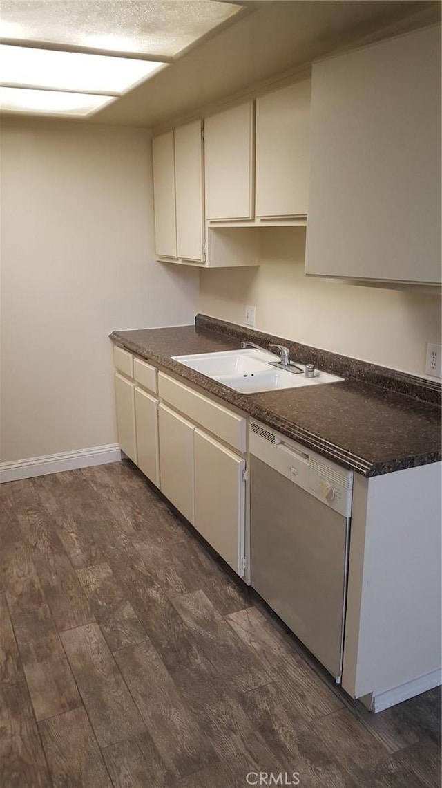 kitchen featuring white cabinetry, dishwasher, sink, and dark hardwood / wood-style flooring