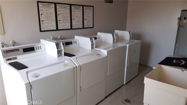 clothes washing area featuring sink and washer and clothes dryer