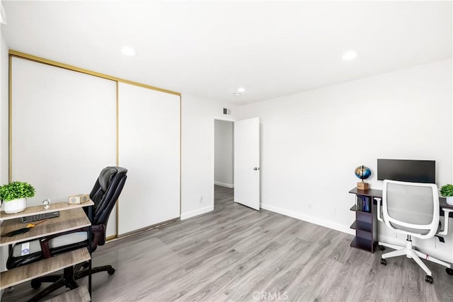 office space with light hardwood / wood-style flooring