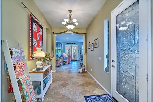 foyer with an inviting chandelier