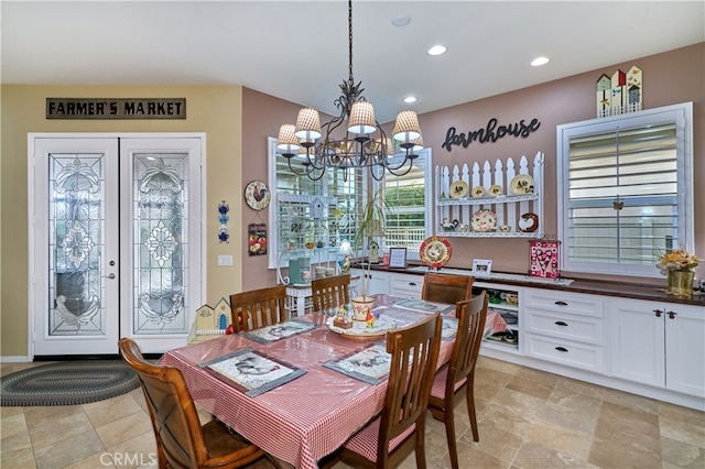 dining space with french doors and a notable chandelier