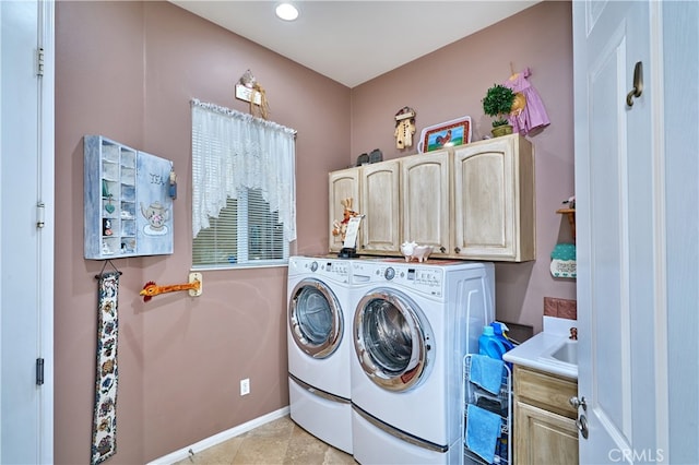 clothes washing area featuring independent washer and dryer and cabinets