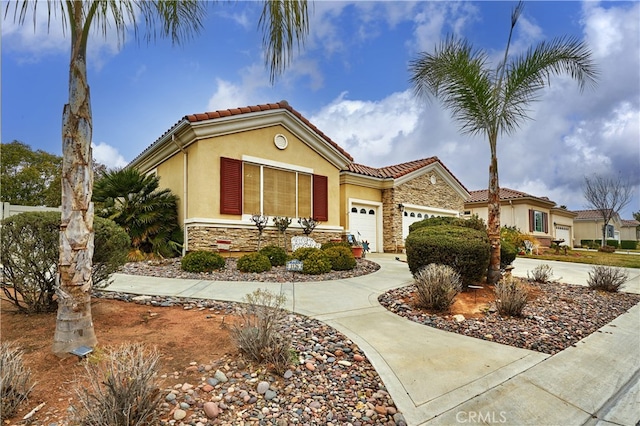 mediterranean / spanish-style house with a garage