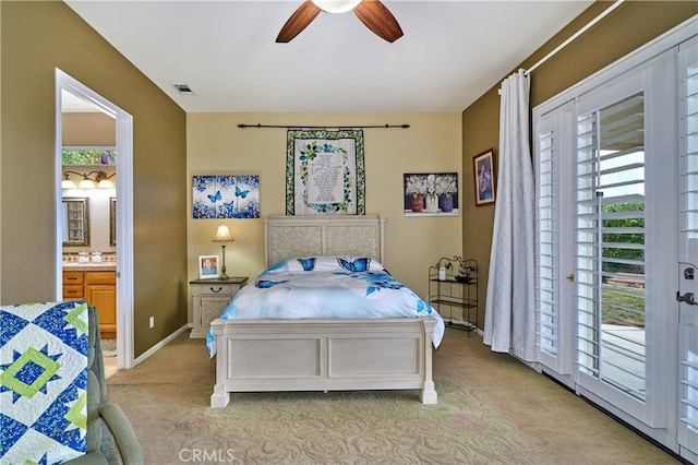 carpeted bedroom featuring ensuite bath, access to outside, and ceiling fan