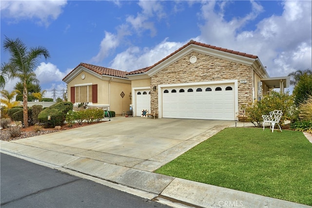 mediterranean / spanish-style home with a garage and a front yard