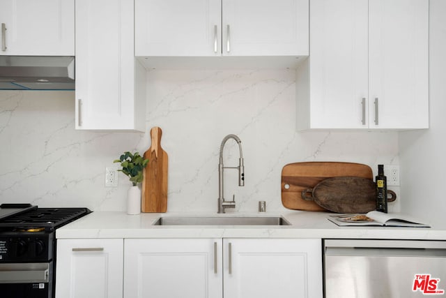 kitchen featuring white cabinetry, dishwasher, sink, black gas stove, and wall chimney range hood