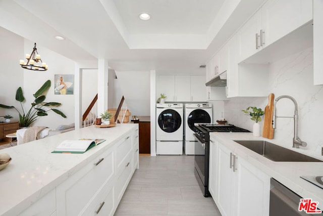 kitchen with dishwasher, sink, white cabinets, gas stove, and washer and clothes dryer