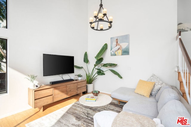 living room featuring hardwood / wood-style floors and a notable chandelier