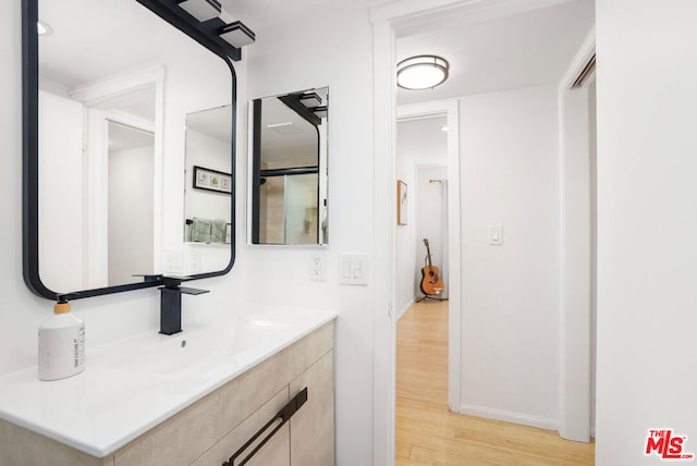 bathroom featuring hardwood / wood-style flooring and vanity