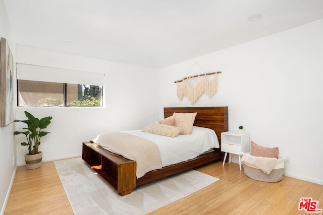 bedroom with hardwood / wood-style flooring