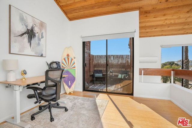 office space featuring vaulted ceiling, wooden ceiling, light hardwood / wood-style floors, and a wealth of natural light