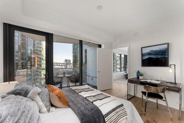 bedroom featuring access to outside and light hardwood / wood-style flooring