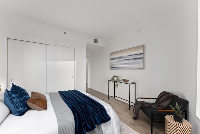 bedroom featuring a closet and light wood-type flooring