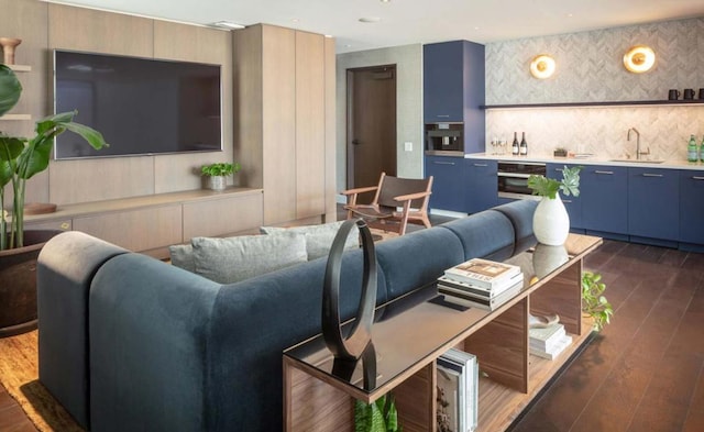 living room with dark hardwood / wood-style floors and wet bar