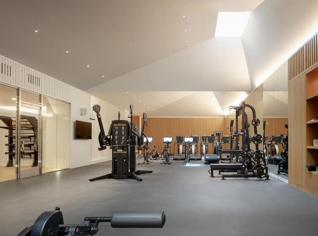 exercise room with high vaulted ceiling