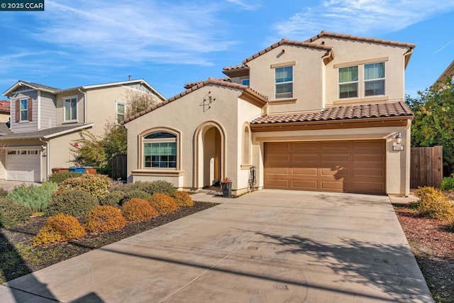 mediterranean / spanish house featuring a garage