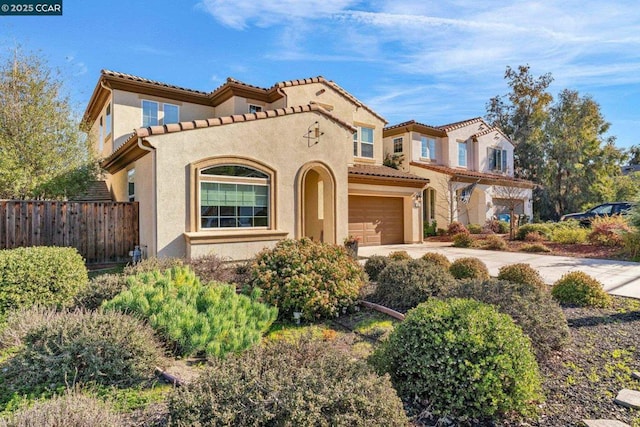 mediterranean / spanish-style home featuring a garage