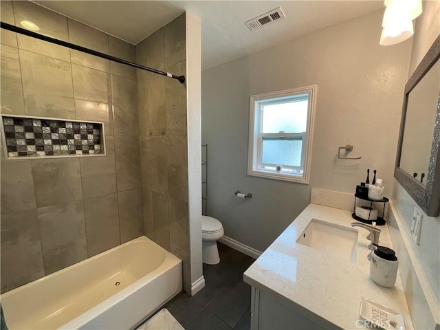 bathroom featuring visible vents, toilet, tub / shower combination, vanity, and baseboards