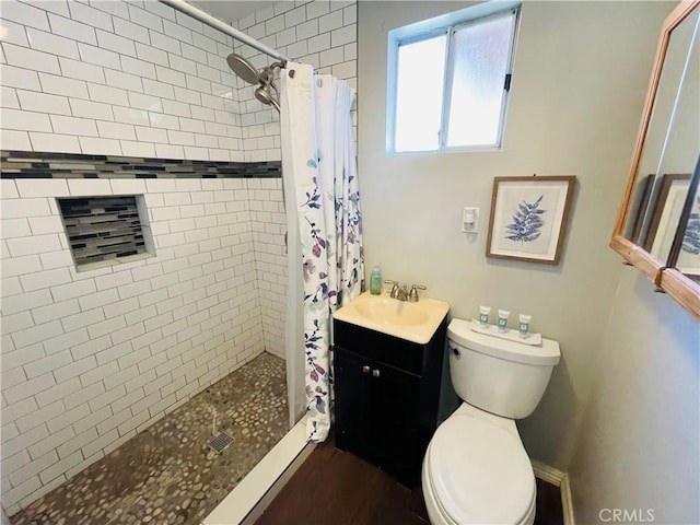 full bath featuring vanity, a shower stall, and toilet