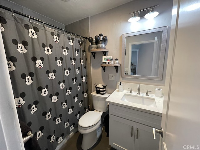 bathroom with curtained shower, vanity, and toilet