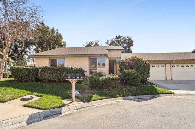 view of front of house with a garage and a front yard