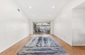 interior space with vaulted ceiling and wood-type flooring