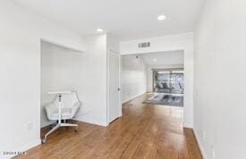 hallway with wood-type flooring