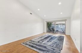 interior space featuring lofted ceiling and hardwood / wood-style floors