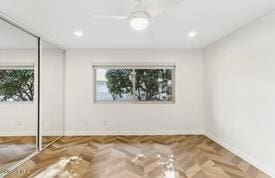 spare room featuring parquet floors and ceiling fan