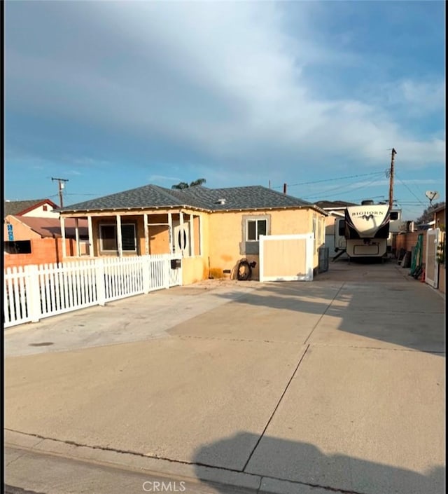 ranch-style house with fence and stucco siding