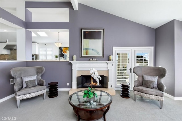 sitting room featuring vaulted ceiling, light colored carpet, and a premium fireplace