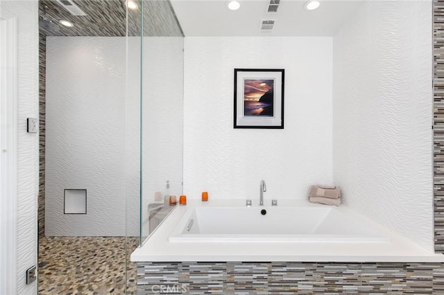 bathroom featuring separate shower and tub