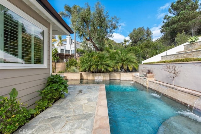 view of swimming pool with pool water feature